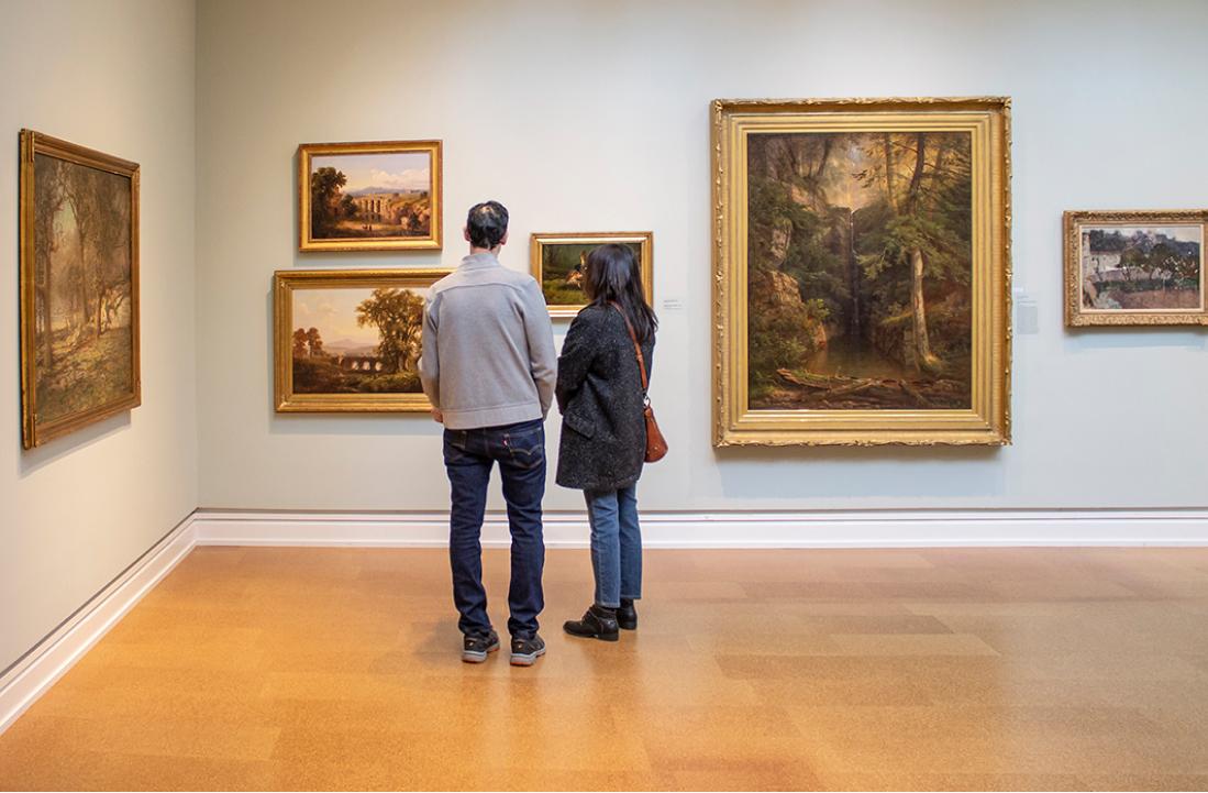 Two people looking at hung art at The Westmoreland