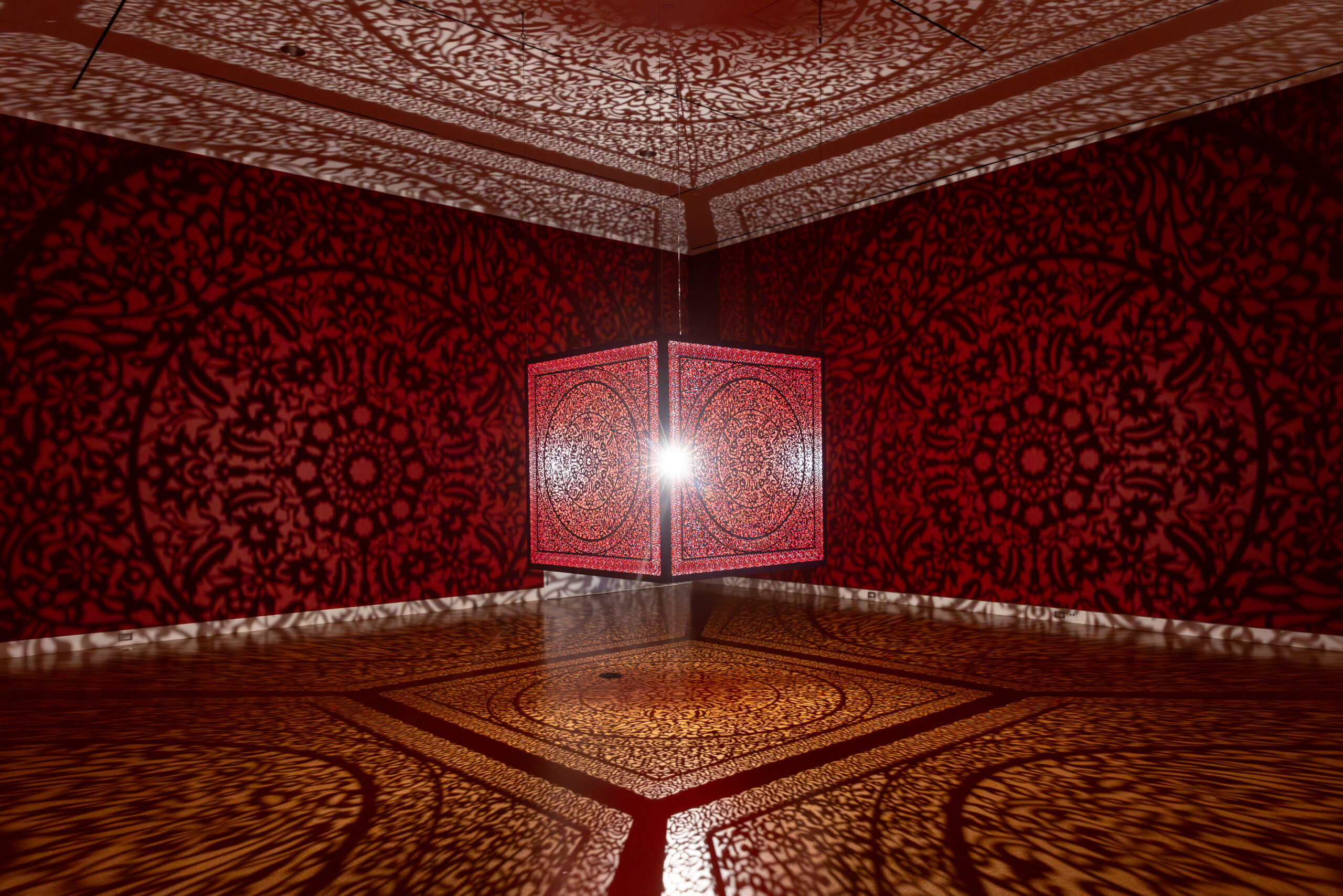 Anila Quayyum Agha, All the Flowers Are for Me (Red), 2016. Lasercut lacquered stainless steel and halogen bulb, Cincinnati Art Museum. Purchase, Alice Bimel Endowment for Asian Art © Anila Quayyum Agha