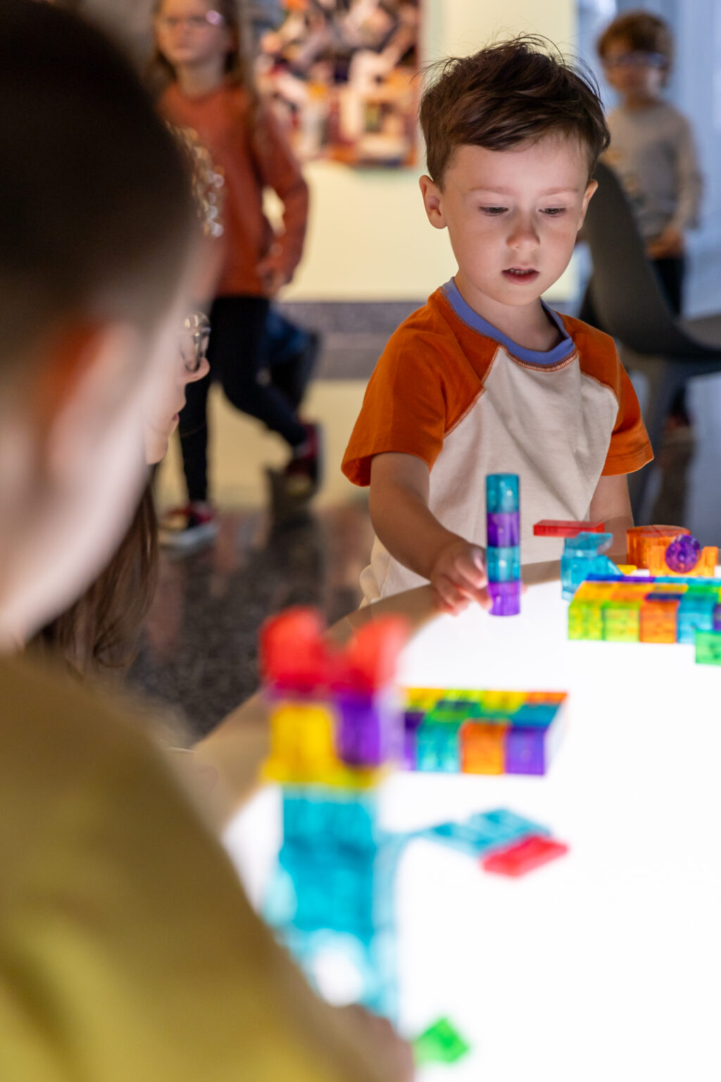 Children enjoying gallery interactive light table